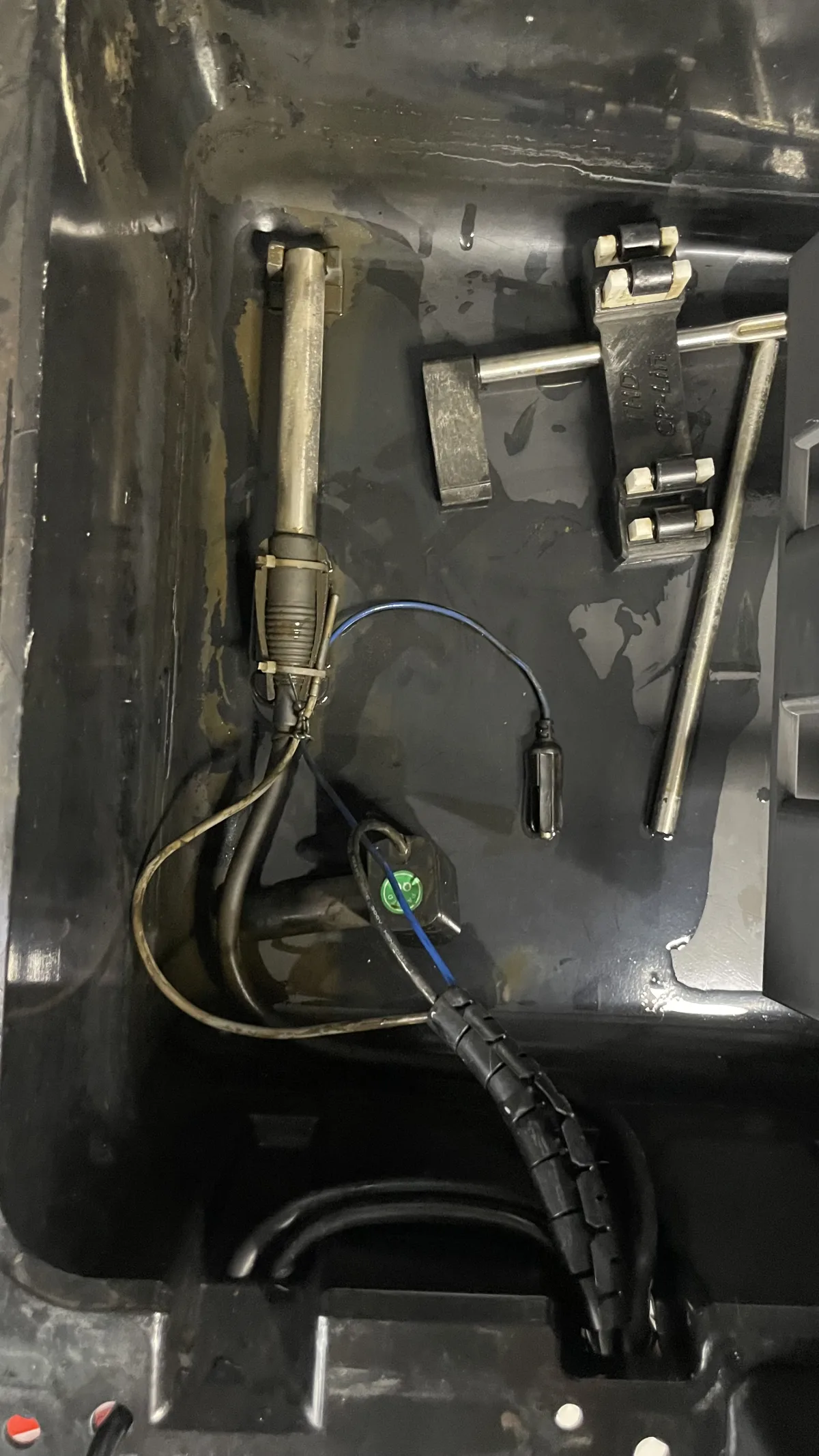 THD Lift bath interior with the control module removed, showing the tubular immersion heater, a probe on a blue lead, and a compact pump assembly
